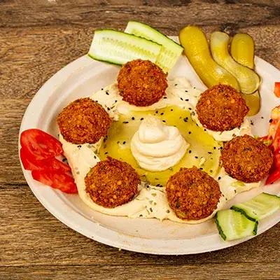 petra-tampa-hummus-falafel-middle-eastern.jpg Authentic Middle Eastern hummus with falafel, pickles, and fresh veggies at Petra Tampa