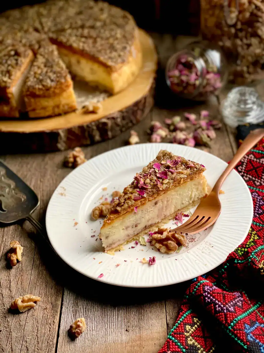 Baklava cheesecake topped with walnuts and rose petals – Mediterranean dessert at Petra Restaurant in Tampa