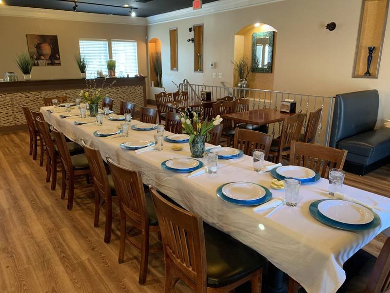 Interior dining room at Petra Mediterranean Restaurant on Kennedy Blvd in South Tampa set for a family-style meal